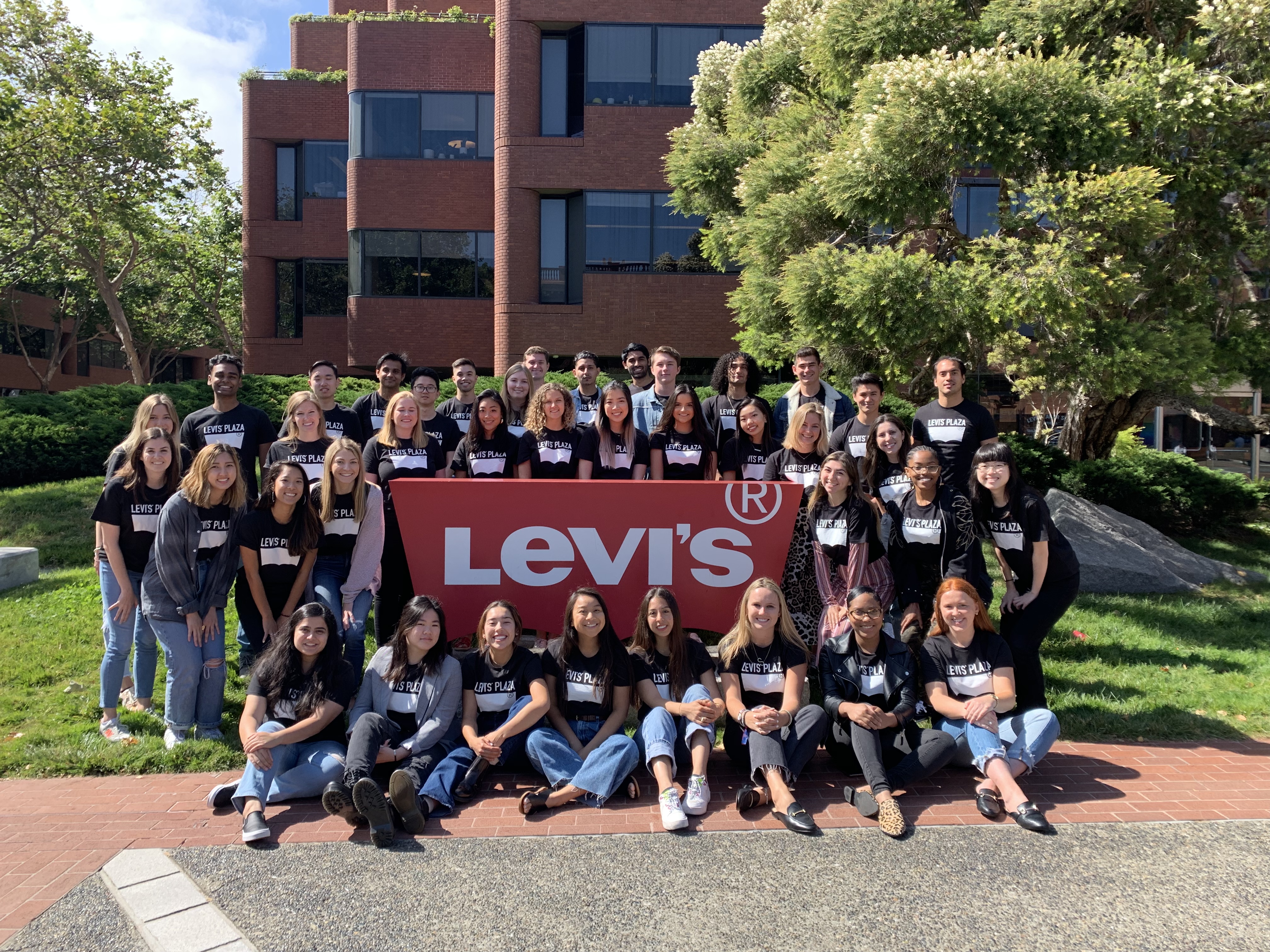 group of LS&Co. interns in front of Levi's sign at the San Francisco headquarters