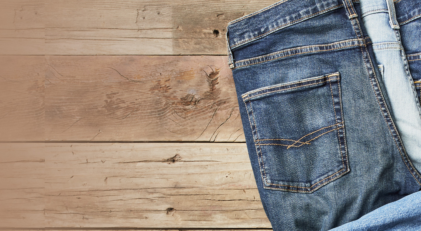 folded Signature by Levi Struass jeans on a wooden floor