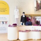 The interior of a Beyond Yoga® store featuring products folded on a white center display.