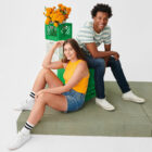 Women in Levi's® jean shorts and man in Levi's® jeans sitting down and posing in product.