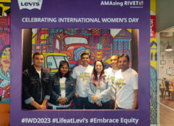 Six LS&Co. employees stand in a purple International Women's Day frame with Levi's® logo and hashtags #IWD2023, #LifeatLevi's and #EmbraceEquity 