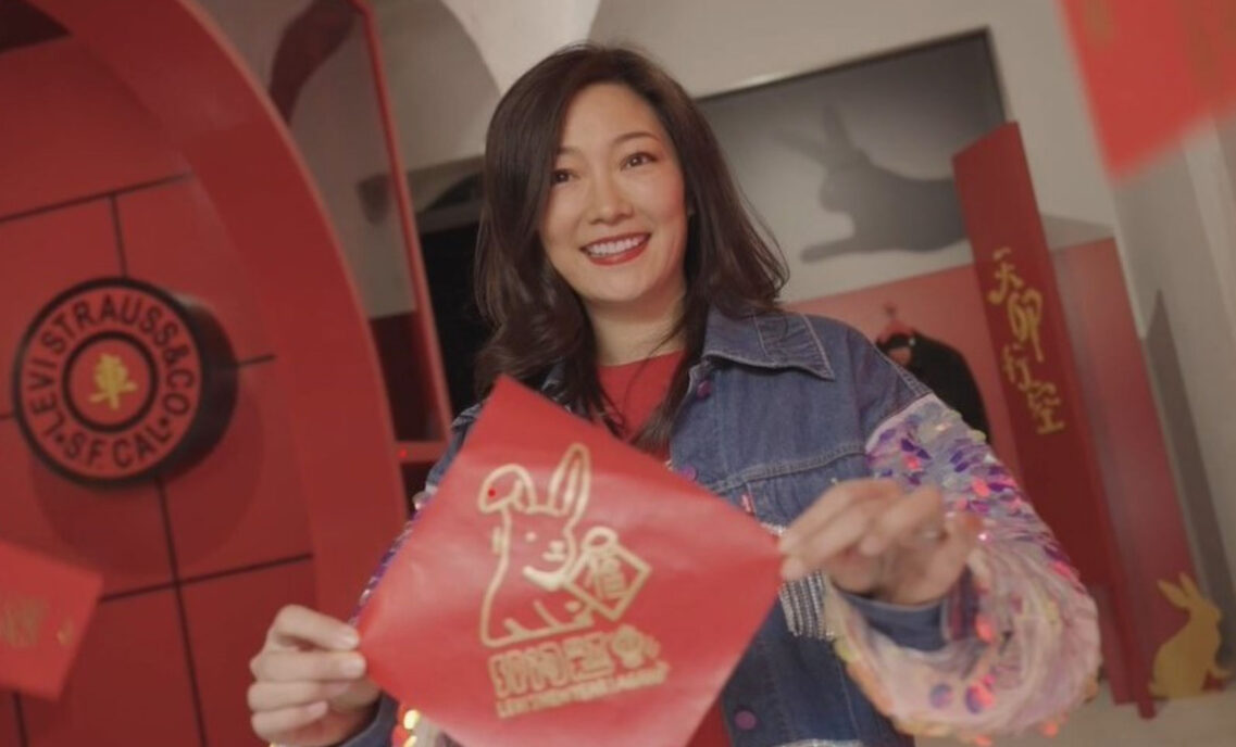 Greater China managing director Amy Yang holds up a Year of the Rabbit red envelope.