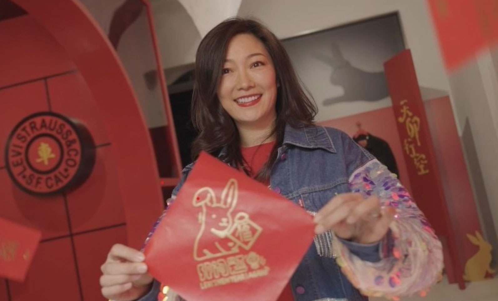 Greater China managing director Amy Yang holds up a Year of the Rabbit red envelope.