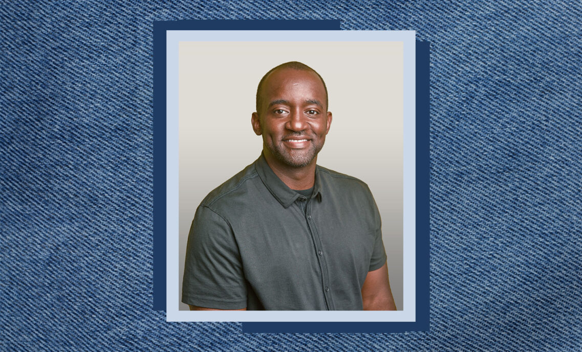 Kenny Mitchell headshot on denim texture background