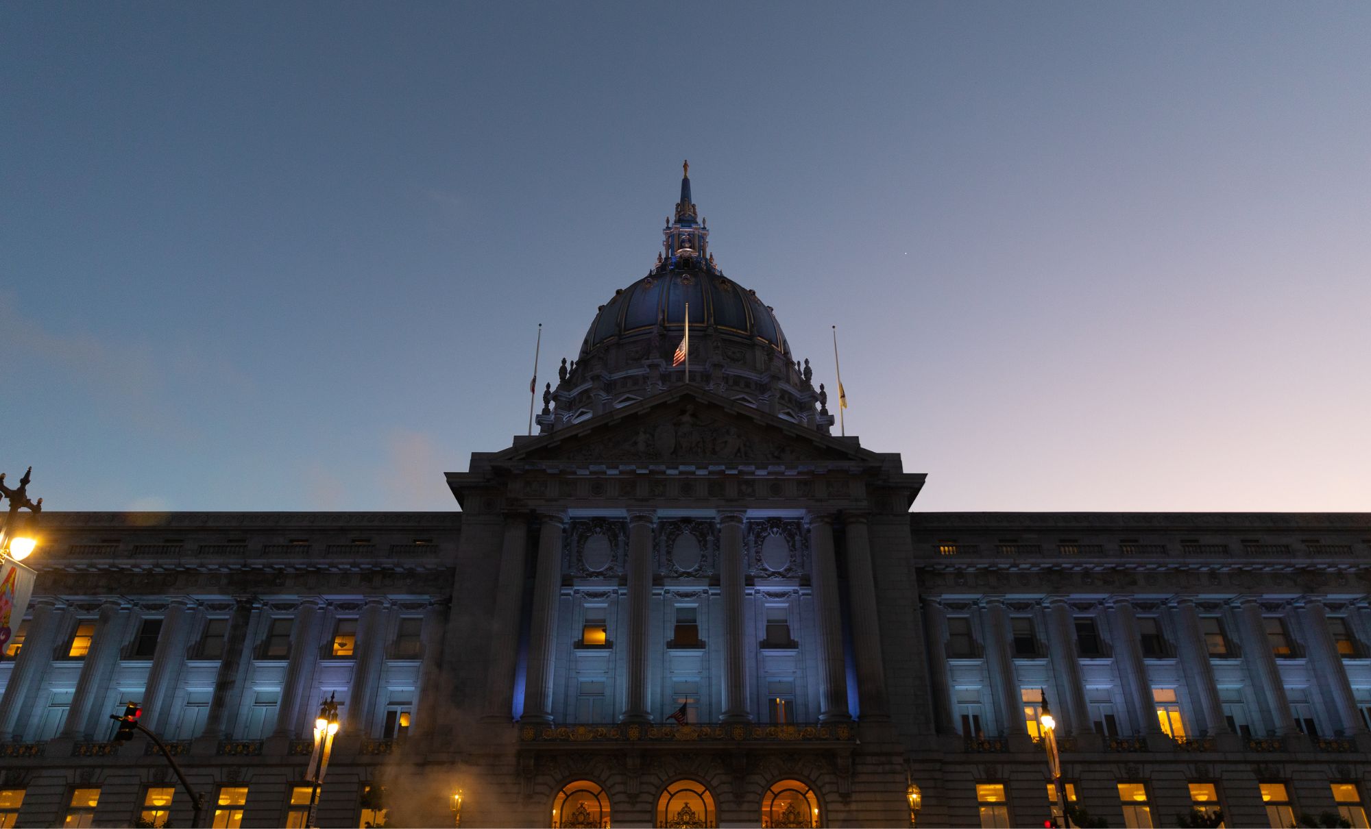 San Francisco City Hall lit up in blue at dusk