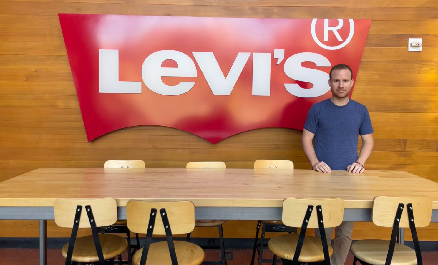 LS&Co. employee Preston Zorner standing in front of a Levi's® logo sign.