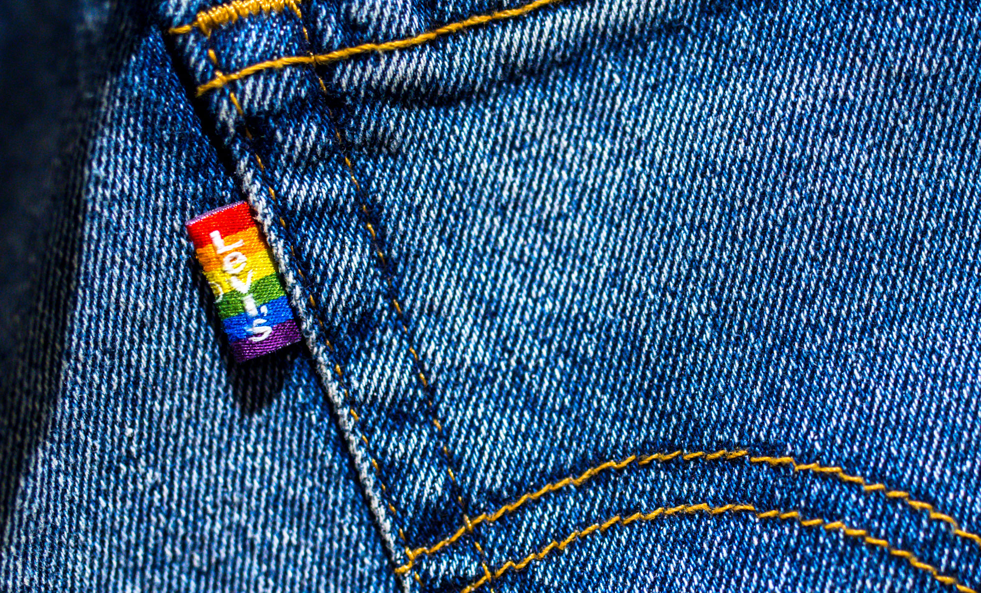 Close-up photo of the Levi's® Pride tag on the back pocket of a pair of jeans.