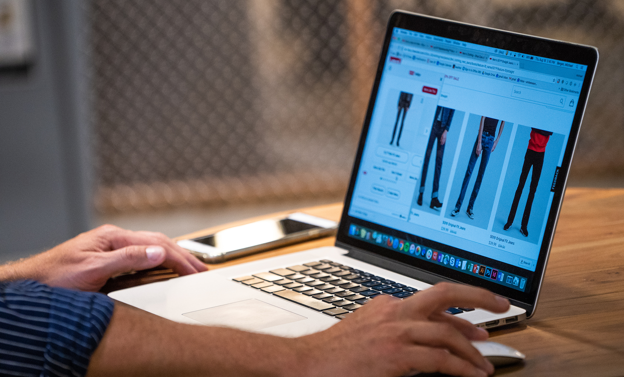 a laptop screen shows products on the Levi's® website
