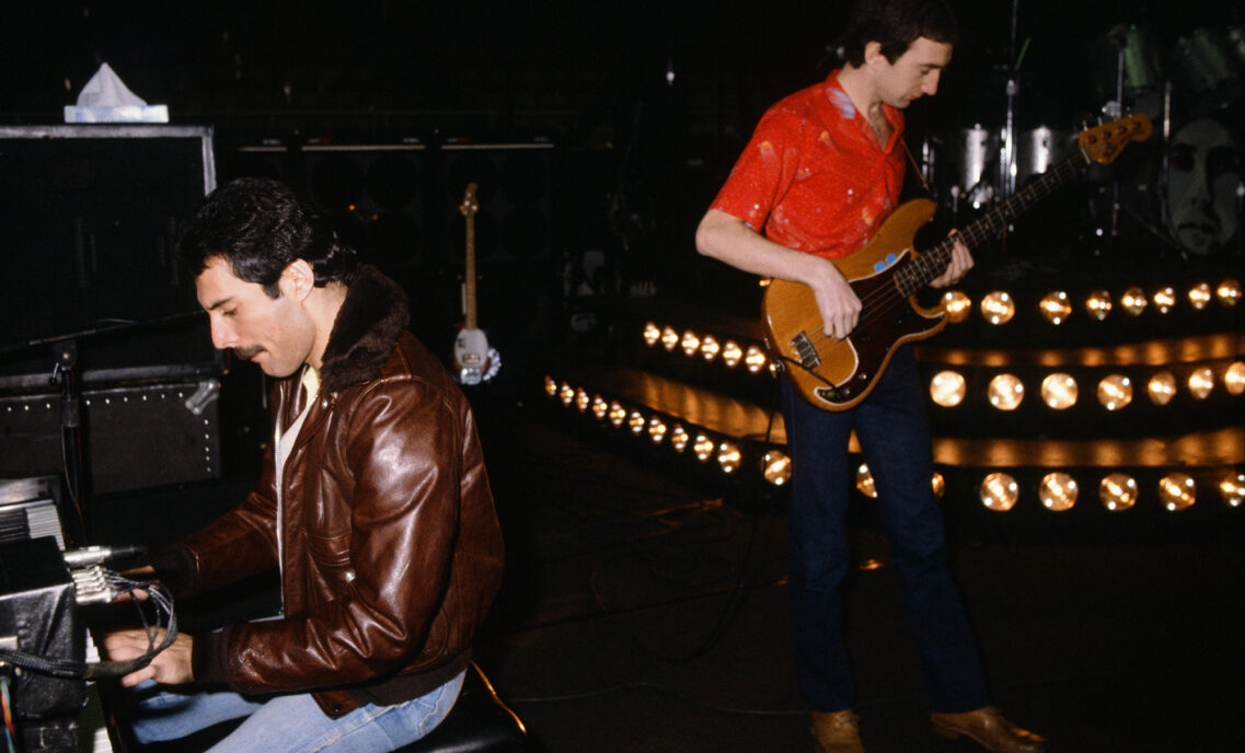 GETTY photo shows Freddie Mercury wearing a brown leather jacket — and what looks like Levi’s® 501® jeans — sitting at the piano while he and John Deacon, also wearing Levi’s® jeans, rehearsed at the Budokan.