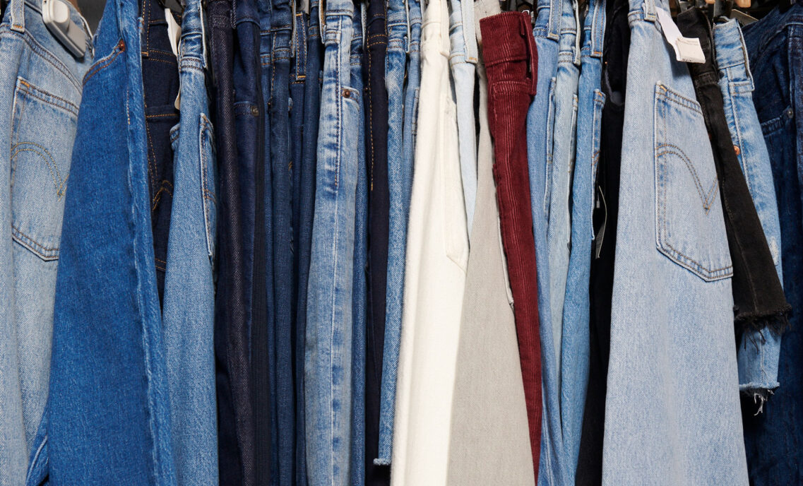 Various washes of Levi's® denim jeans hang next to each other