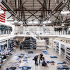 An interior shot of the LS&Co. Eureka Innovation Lab in San Francisco featuring piles of denim jean samples on the floor and employees looking through them.