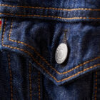 A zoomed in image of a Levi's® dark wash denim jacket, featuring a rainbow Levi's® pride tab next to the front pocket.