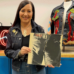 LS&Co. Historian Tracey Panek holds a Rolling Stones "Sticky Fingers" record.