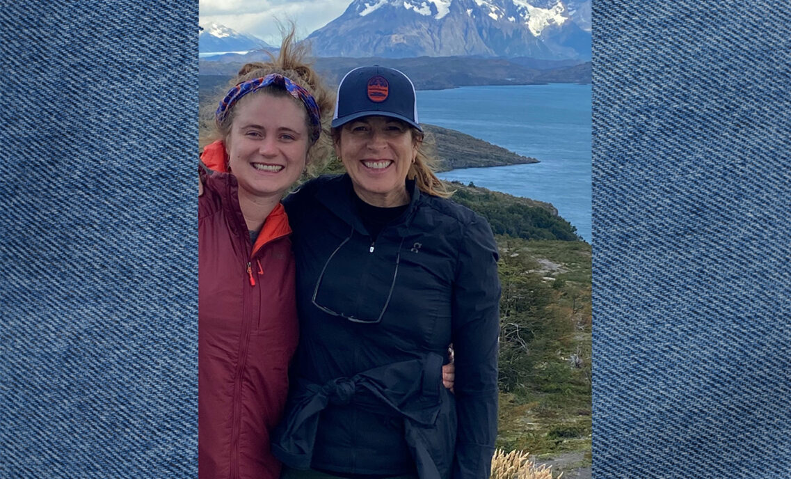 Beyond Yoga® CEO Nancy Green and her daughter stand in front of a mountain lake.