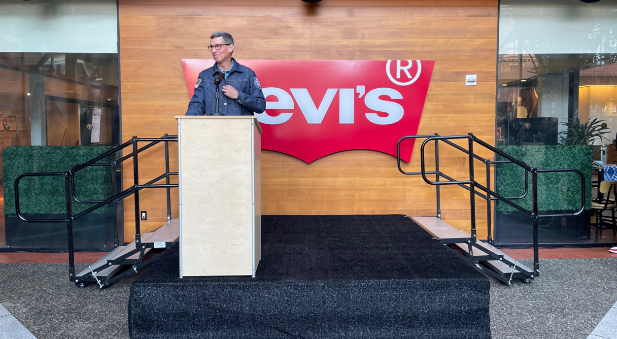 CEO Chip Bergh standing at a podium in front of the Levi's batwing logo