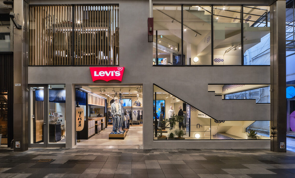 The exterior of the Levi's® store in Kyoto, Japan, featuring large windows and a Levi's® logo above an open doorway leading to mannequins.