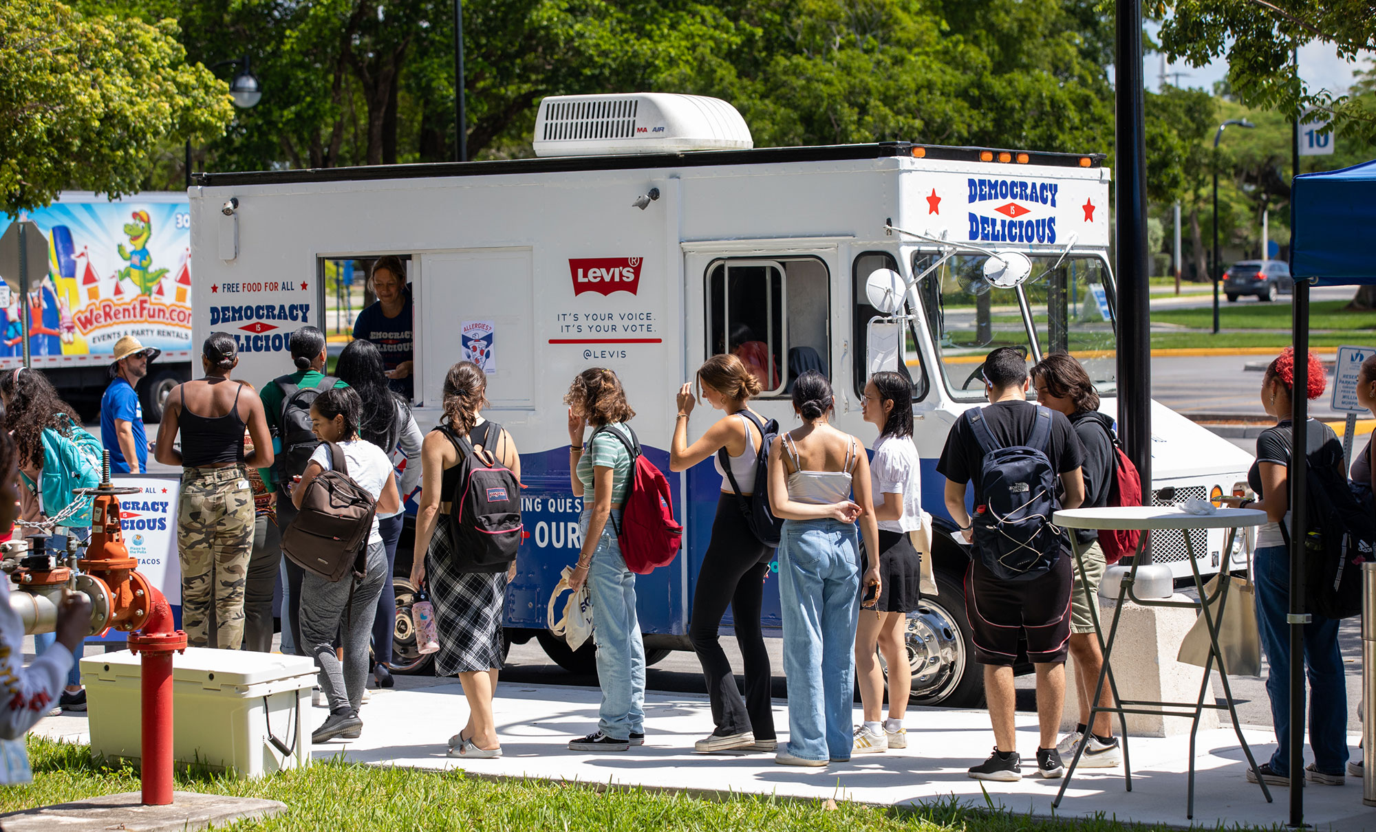 A group of community college students line up by a white truck with the Levi's® logo reading "It's your voice. it's your vote."