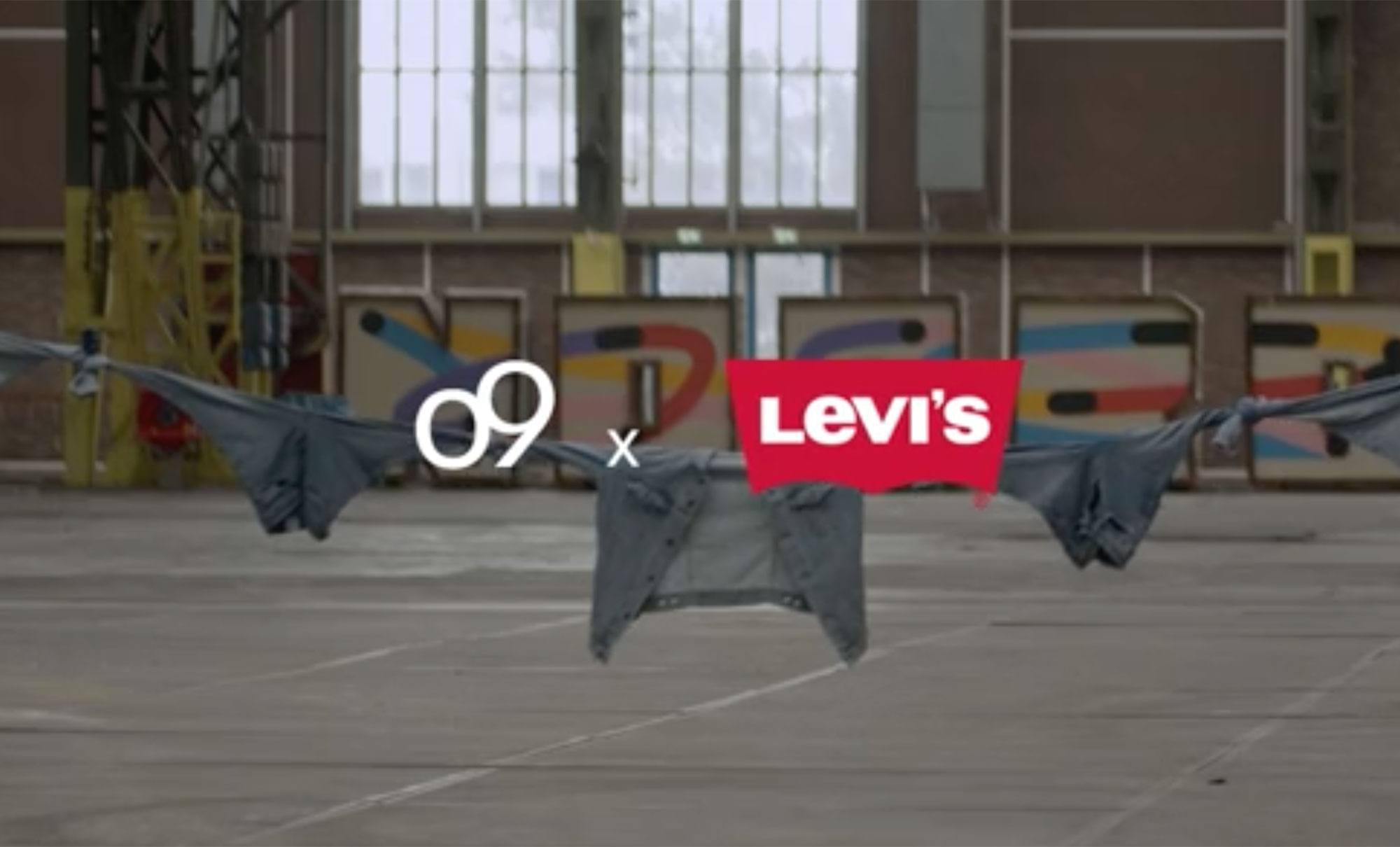 a white o9 logo x a red Levi's® logo are imposed over a photo of various Levi's® denim tied together as a rope and held up in an industrial warehouse.