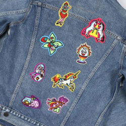 The back of a denim jacket featuring eight embroidered Pride 2025 patches by  San Francisco–based tattoo artist José Luis Sanabria of Castro Tattoo