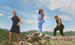 three individuals stand outdoors on boulders wearing Beyond Yoga® product for the brand's Seek Beyond campaign