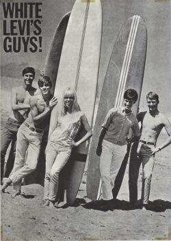 a black and white image featuring five figures leaning against three surfboards propped up in the sand on a beach. Text in the upper left corner reads "White Levi's guys!"