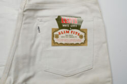 a photo of the back pocket of a pair of Levi's® white jeans. a product sticker on the pocket reads "Levi's white Levi's. Slim Fits. The pants with the famous fit. Lean, hip hugging, masculine fit. Toughest fabric for longer wear. double stitched throughout with strongest thread. sanforized fabric. Levi Strauss & co."