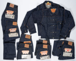 A collection of dark wash Levi's Western denim jackets and jeans