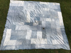A patchwork white and light blue quilt made of old Levi's® jeans