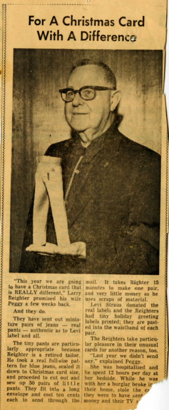 A newspaper clipping with the headline "For a Christmas Card with a Difference" above a photo of a man wearing glasses holding a pair of small jeans in his hand