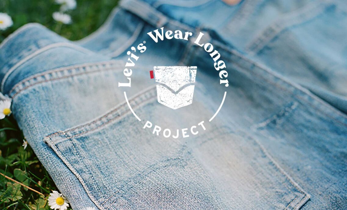 a photo of the back pockets of a pair of denim jeans lying on grass overlaid with a graphic logo reading "Levi's® wear longer project"