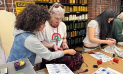 Two San Francisco high school students work at a table on a sewing project as part of a Levi's® Wear Longer Project workshop at the LS&Co. Eureka Innovation Lab