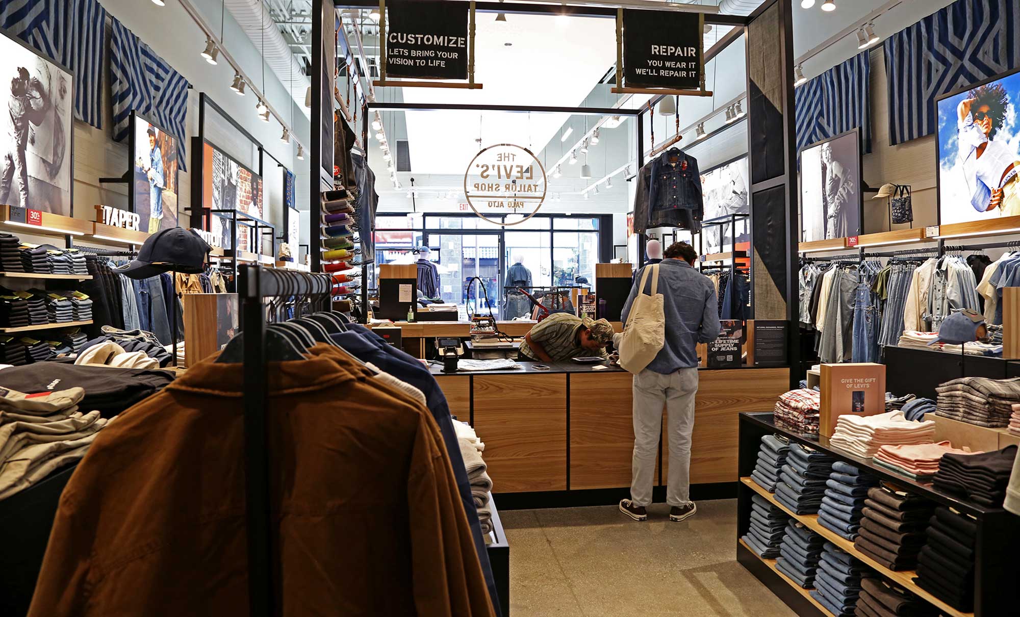 A Levi's® consumer stands at the Levi's® Tailor Shop inside a Levi's® retail location
