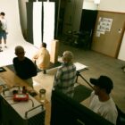 Members of the Levi's® Global Brand Creative Photo Studio team style a model in the photography studio room