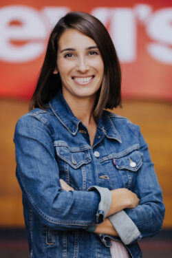 Jennifer DuBuisson, senior director of sustainability at Levi Strauss & Co., poses for a headshot wearing a Levi's® denim jacket with her arms crossed
