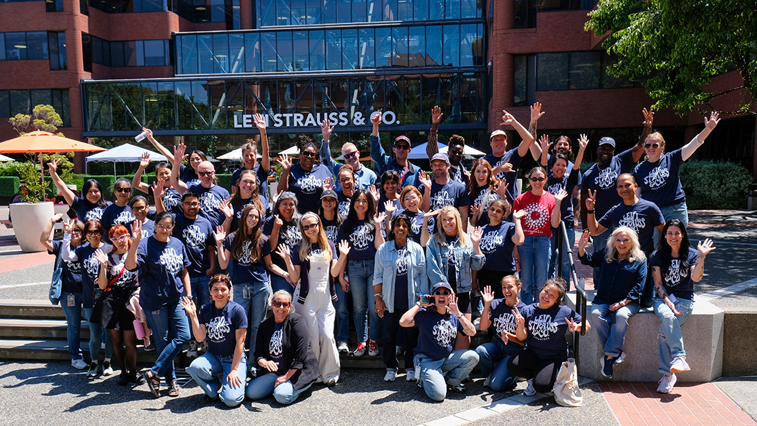 A group of LS&Co. employee volunteers pose in front of the LS&Co. headquarters in San Francisco wearing their volunteer T-shirts