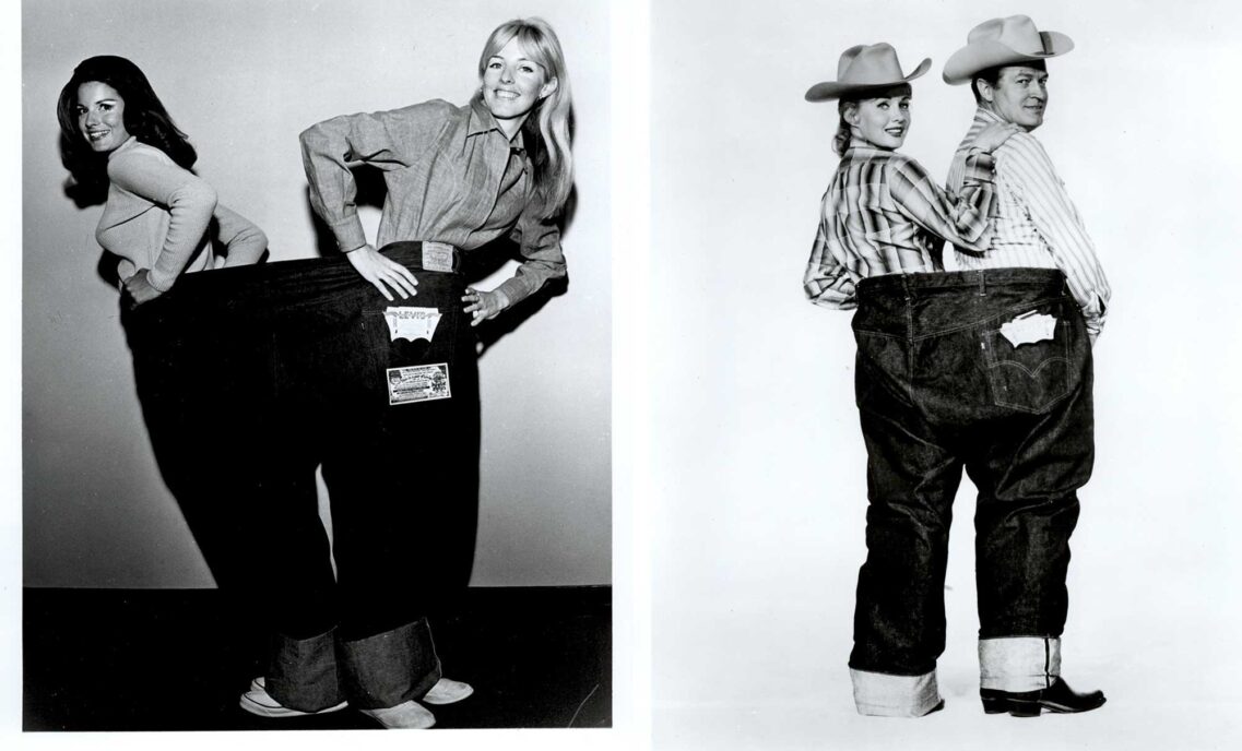 Two black and white photos show two people sharing a pair of jumbo Levi's® jeans, each person standing in one leg