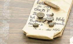 rusted LS&Co. rivets and buttons sit on a note pad with notes about the items