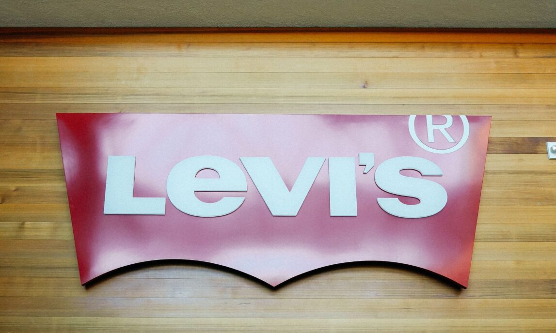The Levi's red batwing logo on top of a wood paneled wall